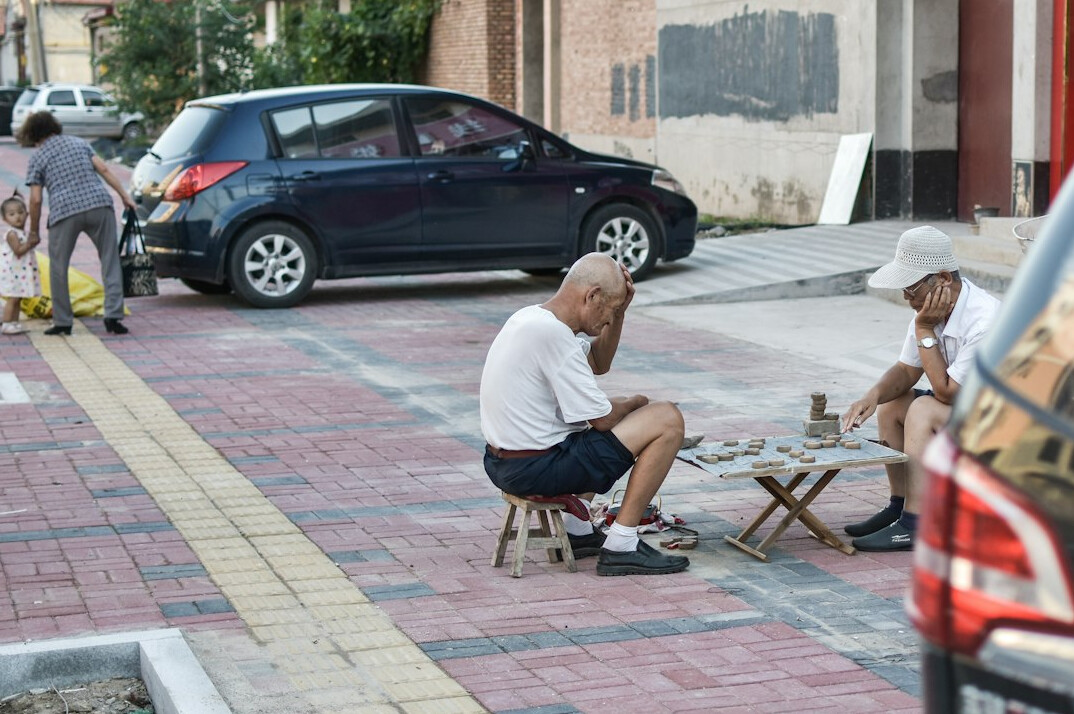 Older adults sharing tea and conversation around a table in a community center