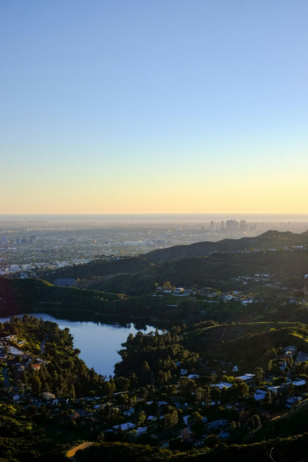 View of a hillside park above a city at early morning with a walking path