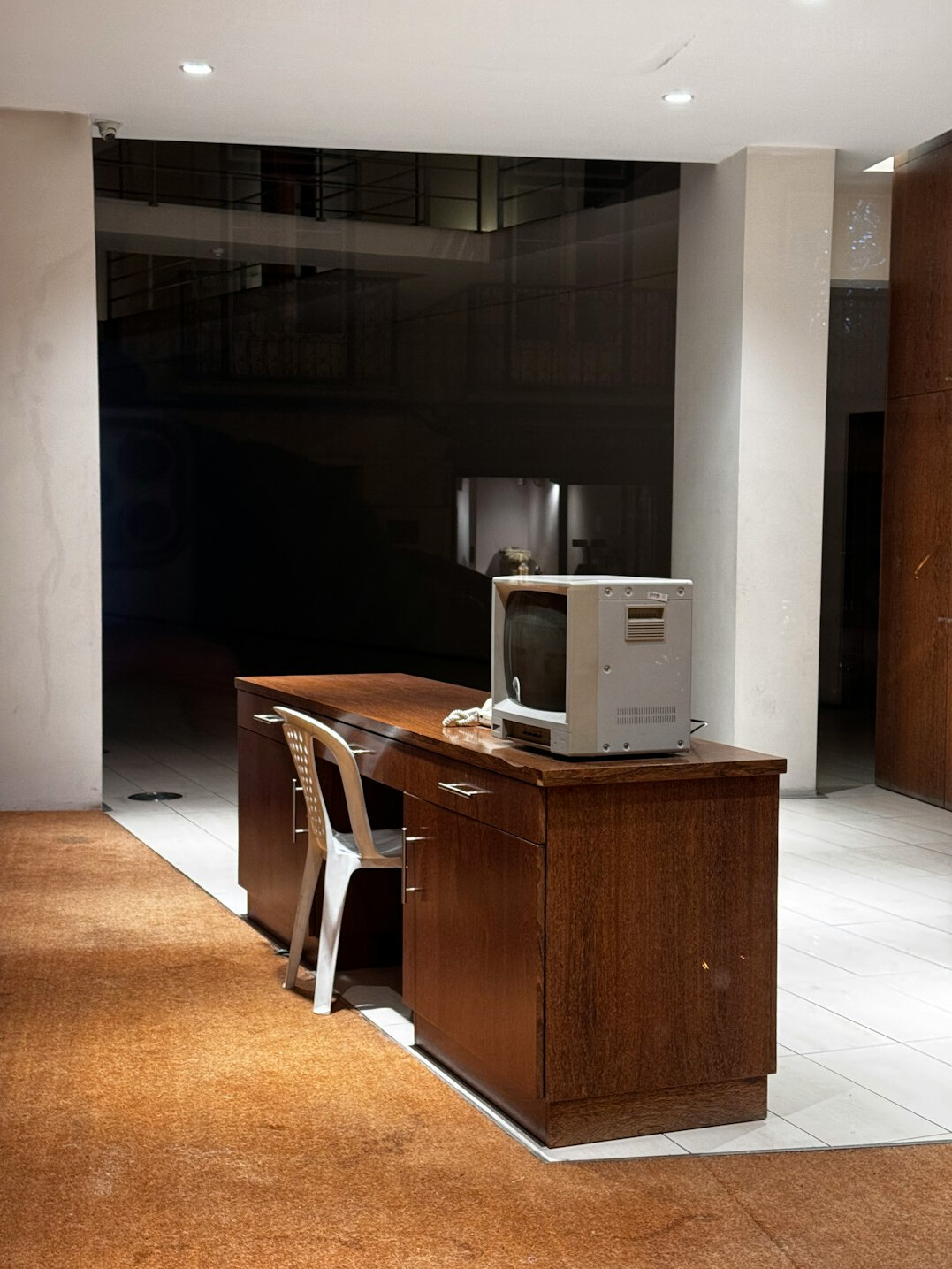 Welcoming reception desk with a notebook, a plant and a telephone in a bright office