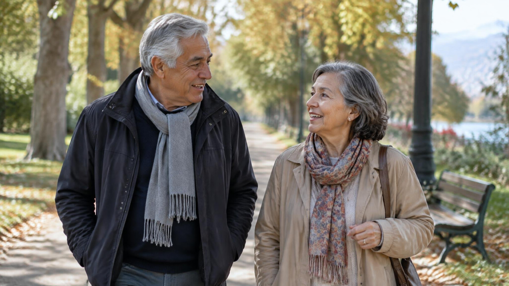 Older Chilean couple walking together on a tree-lined path in autumn light